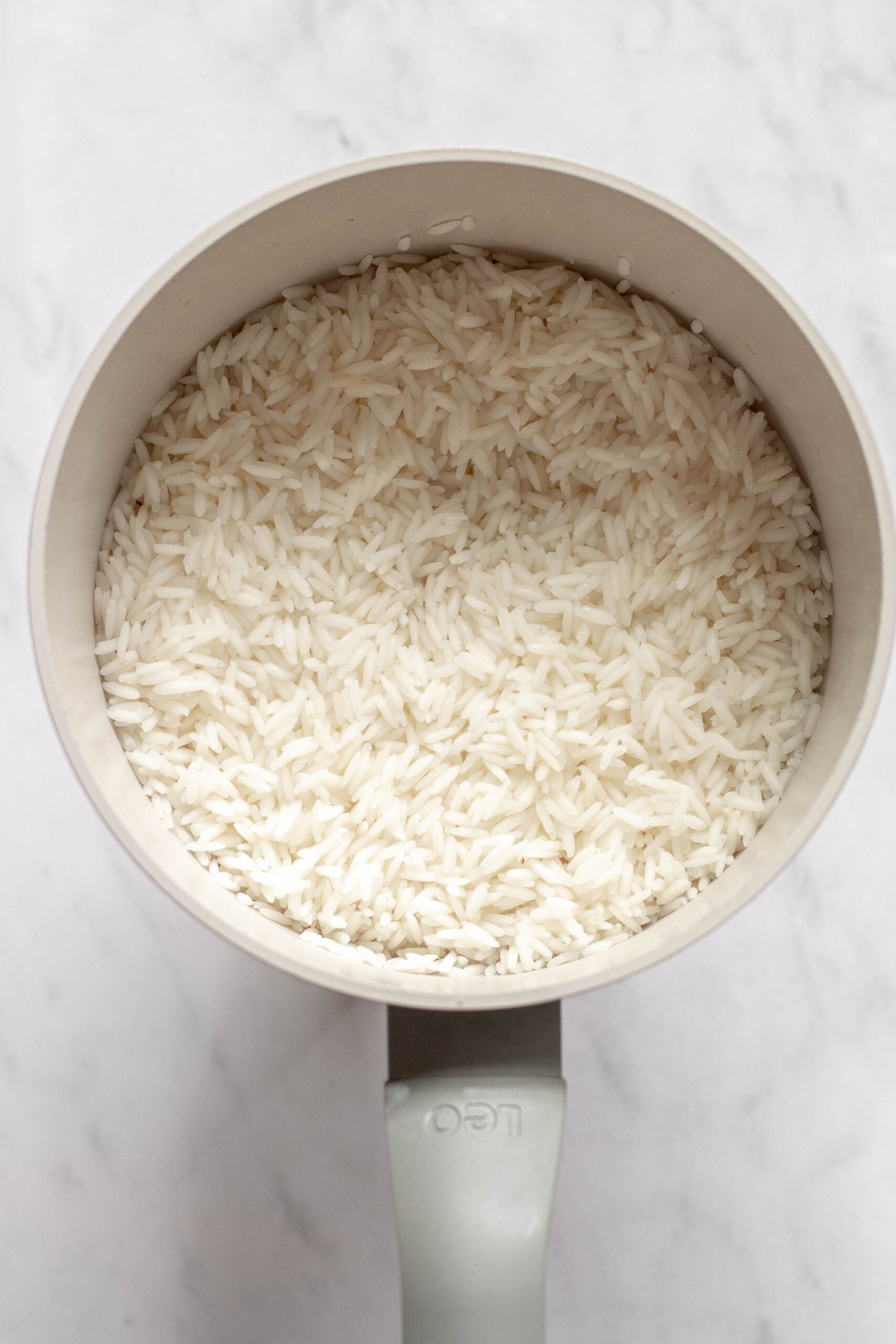 cooked rice for coconut rice pudding in a saucepan